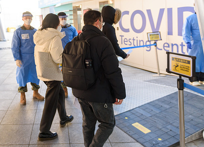Quarantine officials dressed in personal protective equipment (PPE) seen guiding PCR tests for travelers arriving from China in COVID-19 testing station at Incheon International Airport, west of Seoul. South Korea started requiring COVID-19 testing for arrivals from China at Incheon International Airport, the gateway to South Korea.
