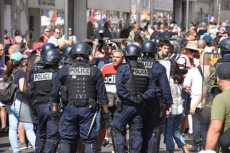 A protester speaks to police officers during the demonstration.Thousands of people demonstrated against the health pass in Marseille, France. French President Emmanuel Macron announced among new anti-Covid 19 measures a "health pass" which will be necessary to be frequenting café terraces, restaurants, cinemas, theatres and other culture and leisure activities to help contain the spread of the Covid-19 virus.