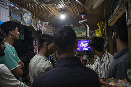 Kashmiri residents watch the live broadcast of the Group A T20 Asia Cup match between arch-rivals India and Pakistan on a television screen inside a shop in Srinagar. Protesters in India have called on the government and cricket board to withdraw from the match against Pakistan following cross-border clashes in May, amid growing boycott calls. Some fans also petitioned the Supreme Court to cancel the game, arguing that playing Pakistan would hurt the sentiments of families who lost relatives in the conflict and in a gun attack in India-administered Kashmir that killed 26 Hindu tourists. The match at the Dubai International Cricket Stadium carries higher stakes than usual given the political tension between the two nations.