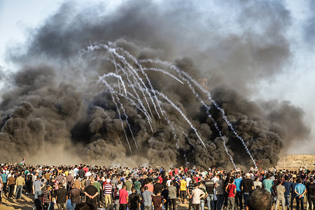 Tear gas and smoke seen fired by Israeli forces into a huge crowd during the clashes.
Clashes between Palestinian protesters and the Israeli forces during a protest along the Israeli fence East of Gaza City.