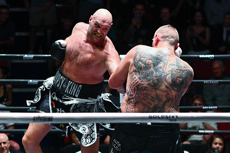 Tyson Fury (L) and Mariusz Wach (R) trading punches during their heavyweight boxing bout. Tyson Fury defeats Mariusz Wach by corner retirement after seven rounds to win the WBC Humanitarian Belt at Max Muay Thai Stadium.