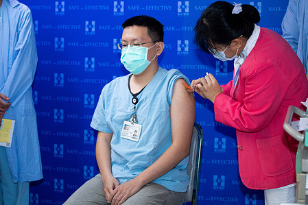 A healthcare worker receives a first shot of COVID-19 vaccination.
Health care workers receive the first AstraZeneca vaccinations at Shin Kong Wu Ho-Su Memorial Hospital in Taiwan.