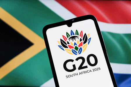 In this photo illustration, the G20 Johannesburg Summit logo is seen displayed on a smartphone screen with a South African flag in the background.