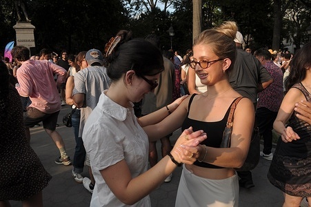 A pair dances in a salsa dance event in Washington Square Park, Manhattan, New York City.