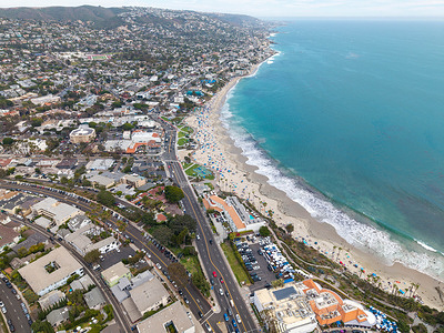 (EDITORS NOTE: Image taken with drone) An aerial view shows beachgoers filling Main Beach in Laguna Beach during the Independence Day holiday weekend on July 4, 2026. Southern California beaches experienced heavy attendance as residents and visitors gathered along the coast to celebrate the Fourth of July amid warm summer weather.