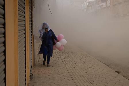 A woman covers her face with a shawl while passing through a mass of dust and air pollution during the Road construction at Pulatisadak in Kathmandu.
The road repair started from mid April amidst the enforcement of the lockdown against the coronavirus.