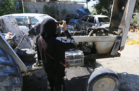 A Palestinian takes pictures of a burning car after it was set ablaze by Jewish settlers in the village of Ramin, west of Nablus in the West Bank. Local residents said a group of Jewish settlers attacked Palestinian homes, that they set fire to a car and a tractor, and threw stones at the houses.