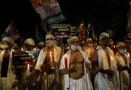 Activists marching with candles during the demonstration.
Activists of Indian Youth Congress, dressed as Mahatma Gandhi on the occasion of his birth anniversary marked as the 'Gandhi Jayanti' day, in a Candle March protest against the death of a 19-year-old woman who was allegedly gang-raped in Hathras.
