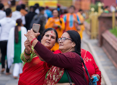 Elderly women take a selfie after visiting the temple during the Shrawan Brata festival in Kathmandu. During the month of Shrawan, each Monday Nepalese Hindu women worship Lord Shiva for a long and prosperous life for their husband or to get a good one.