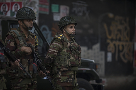 Bangladeshi Military force soldier stands alert in Dhaka City during the 13th National Parliament Election and referendum. Voting takes place simultaneously in 299 constituencies from 7:30 a.m. to 4:30 p.m., with authorities describing the process as largely peaceful despite isolated incidents.