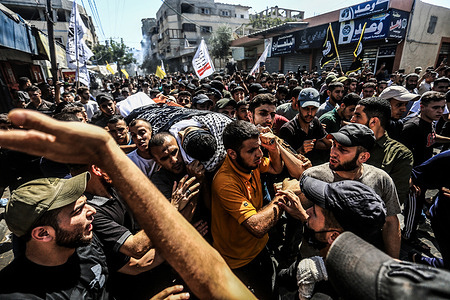 (EDITORS NOTE: Image depicts death) Mourners carry the body of Palestinian Majdi Ghabayen, at his funeral in Beit Lahia in the northern Gaza Strip. Majdi Ghabayen, who died of wounds sustained in an explosion during a rally near the border fence with Israel on September 13.