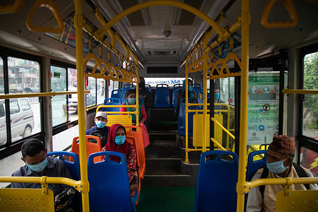 Passengers wearing face masks sit in a bus while maintaining a safe distance.
Nepal government has decided to allow the operation of the public vehicles within the respective district and inside the valley following the Coronavirus (Covid-19) crisis.