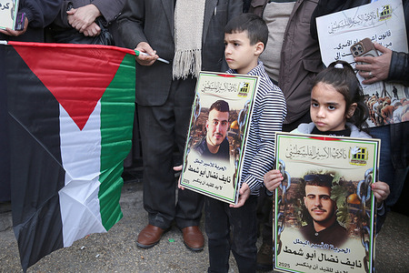 Palestinian children hold portraits of their relatives detained in Israeli prisons during the demonstration in the West Bank city of Nablus. Families whose sons are detained in Israeli prisons gathered to demand their release.