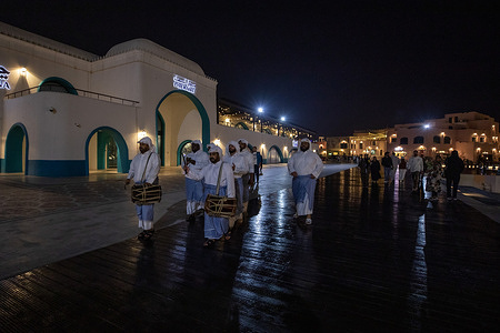A group dressed in traditional Qatari attire, known as the "Musaharati," roam the streets from midnight until just before dawn, beating their drums to wake people for their pre-dawn meal (Suhur) with religious phrases like "There is no god but God... Suhur, O servants of God." Each neighborhood had its own Musaharati, and the tradition is highly valued in Doha, Qatar, where it remains a cherished symbol of heritage in areas like Katara and the old Doha port.