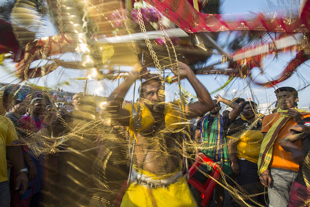 A Hindu worshipper dances while carrying a kavadi, a mobile shrine that can reach 100kg, as an act of self sacrifice during the Thaipusam Hindu festival at Batu Caves temple in Kuala Lumpur. Thaipusam, a celebration that honors the god Murugan, is believed to bring health and prosperity to to the pilgrims willing to make the journey to the temple and give offerings. The Malaysian Thaipusam is the biggest festival of its kind in the world, with more than 1.5 million pilgrims and tourists attending.