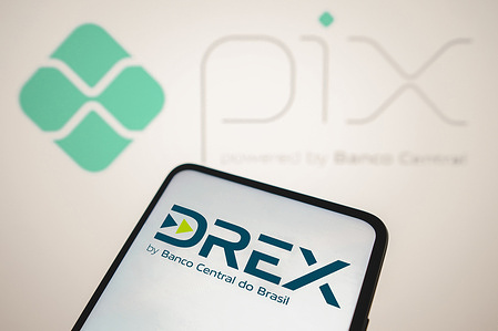In this photo illustration, the Drex logo seen displayed on a smartphone with the Pix logo in the background. Pix is a new IP (instant payment) scheme powered by Banco Central which enables its users to send and receive payment transfers instantly even during non-business days, Drex is the new Brazilian digital currency launched by the Central Bank.