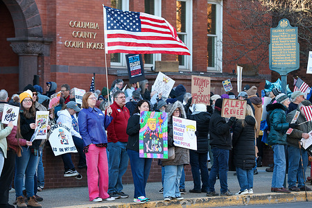Protesters gather outside the Columbia County Courthouse during a "No Kings" demonstration. The event was one of more than 3,300 protests scheduled nationwide on the day, organized in opposition to Trump administration policies.