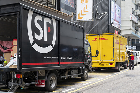 Chinese delivery company SF Express and German express delivery mail company DHL delivery trucks seen in Hong Kong.