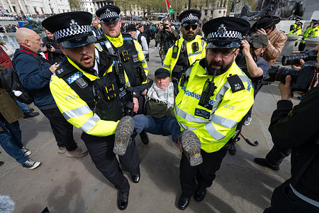 A protester is being arrested by the police for holding a placard reading "I oppose genocide, I support Palestine Action” during the rally. Protesters gathered for a demonstration organised by Defend Our Juries calling for the lifting of restrictions on protest rights in the United Kingdom. More than 300 demonstrators staged a mass sit-in in Trafalgar Square, holding signs reading “I oppose genocide, I support Palestine Action” as part of the protest. Police moved in to arrest participants on suspicion of offences related to displaying support for a proscribed organisation, while activists argue the action highlights concerns over civil liberties and freedom of expression.