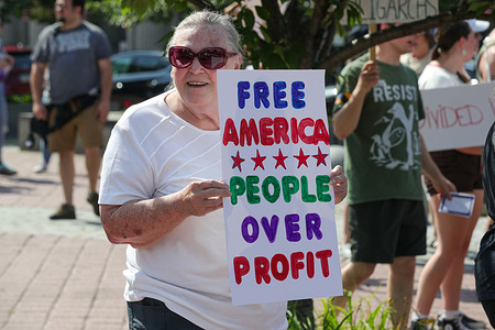 A demonstrator holds a placard during an anti-Trump protest at Wilkes-Barre's Public Square. The protest was part of the Free America actions across the United States on Independence Day weekend.