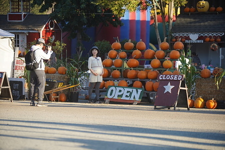 People take photos at the gate of a pumpkin patch.
There are many pumpkin patches open for the people to visit and buy pumpkins before Halloween. Here is a Pumpkin Patch near Half Moon Bay, the owner of this pumpkin patch said there were around 500 people who visited the patch last weekend alone.