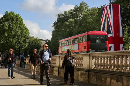 People and a London red bus pass the cenotaph, draped in a Union Flag. A giant Union Flag will cover the Cenotaph on Thursday to mark the 80th anniversary of Victory in Europe (VE) Day, the first time it has been adorned in this way since its unveiling by King George V in 1920. VE Day, observed on May 8, commemorates the Allied victory and Nazi Germany’s surrender in WWII. Organizers aim to recreate the atmosphere of the 1945 celebrations.