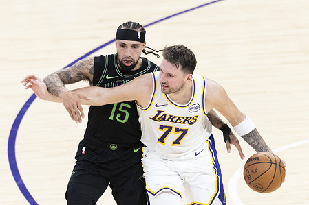 Los Angeles Lakers’ Luka Dončić (77) drives against New Orleans Pelicans' Jose Alvarado (15) during an NBA basketball game at Crypto.com Arena, in Los Angeles Sunday Nov. 30, 2025.