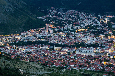 A panoramic view of Mostar from Fortica viewpoint in Mostar, Bosnia and Herzegovina. Mostar is a city with a very rich history, situated in mountainous country along the Neretva River. First human settlements on the Neretva river, have existed since prehistory. Mostar has long been known for its old Turkish houses and Old Bridge, Stari Most, after which it is named. The bridge and the surrounding area were added to UNESCO’s World Heritage list in 2005. The Old Bridge and Old City of Mostar is a symbol of reconciliation, international co-operation and of the coexistence of diverse cultural, ethnic and religious communities.