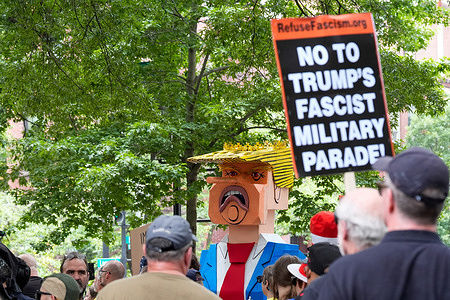 A large puppet of Donald Trump on a toilet is displayed in Logan Circle as part of the Refuse Fascism march, Saturday, June 14, 2025, in Washington. The protests were held around the United States on the same day President Trump held a military parade in Washington in honor of the Army's 250th birthday which coincides with his own birthday.