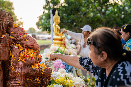 A devotee pours scented water over a statue of Ganesha, ahead of Songkran festivities. Preparation at Wat Chaiwatthanaram ahead of the Songkran kickoff, marking Thai New Year 2026, with vibrant festivities and traditional attire set against one of the most majestic temples of the ancient capital of Thailand, Ayutthaya.