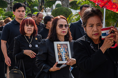 A mourner holds a portrait of Queen Mother Sirikit they pay their respects to the Queen Mother Sirikit at the Dusit Maha Prasat Throne Hall within the Royal Grand Palace in Bangkok. The Bureau of the Royal Household allowed the members of the public to pay their respects to the Queen Mother Sirikit at the Dusit Maha Prasat Throne Hall within the Royal Grand Palace in Bangkok starting on November 9, 2025.