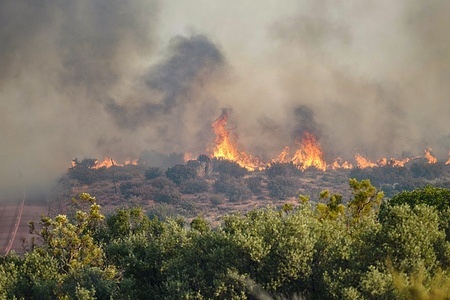 Smoke and flame are seen during the wild Thorn Fire disaster. The Thorn Fire burns near Buckthorn Trail and Clover Trail in the Boulevard/Campo area of southeastern San Diego County on Wednesday, July 15, 2026. Fueled by hot, dry conditions, the wildfire spreads rapidly, prompts evacuation orders and warnings, temporarily closes portions of Interstate 8, and draws a large response from Cal Fire and local agencies. Firefighters on the ground, supported by air tankers and helicopters, work to slow the fire's advance and protect nearby homes and infrastructure as officials monitor changing fire conditions.