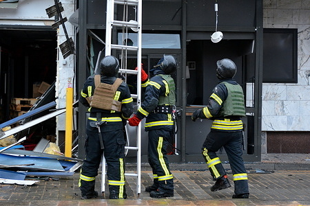 Firefighters work at a site of a Russian missile strike amidst Russia's attack on Ukraine, in Kyiv.