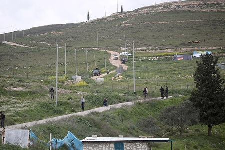 Palestinians throw stones at Jewish settlers as they attempt to establish an outpost in Palestinian agricultural fields at the site where Jewish shepherd Shmuel Sherman was killed in the village of Beit Imrin, north of Nablus in the West Bank.