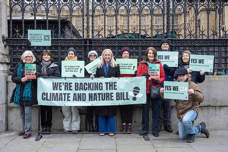Activists pose for a group photo with a member of Parliament, Dr. Roz Savage (centre with blonde hair) who is backing the Climate and Nature Bill. Activists of the Zero Hour gathered to protest outside the Parliament in London because of the campaign of "The Climate and Nature Bill" (CAN). It is a proposed law in the UK that takes comprehensive approach to climate and nature emergency.