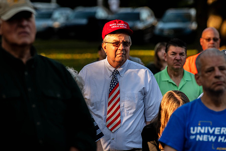 People gather during a vigil for Charlie Kirk. Thousands gathered at the Guilford Soldier's Monument on the historic Guilford Town Green to hold a memorial and prayer vigil for Charlie Kirk, who was killed during a speaking event in Utah.