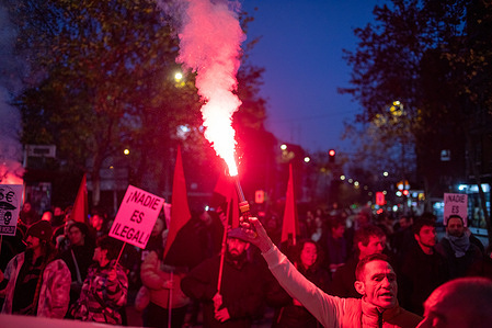 Protesters carry smoke flares during a demonstration. Protesters stage a demonstration organized by various social groups in the Carabanchel neighborhood of Madrid to protest the existence of Foreigners' Detention Centers (CIEs) in the city, which they consider illegal.