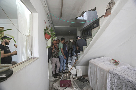 Palestinians inspect the damaged home of Mohammed al-Madani, wanted by the Israeli army in the Balata refugee camp east of Nablus in the West Bank. Mohammed al-Madani, was killed during an Israeli army raid on the Balata refugee camp, east of Nablus in the occupied West Bank.