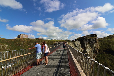 People on the controversial new footbridge re-connecting both halves of Tintagel Castle for the first time in 500 years, has at long last been opened. 
The medieval castle on the Cornwall coast - long rumoured to be the site of King Arthur's legendary Camelot - lost its original bridge sometime between the 15th and 16th centuries. A storm which hit the Cornish coast delayed the bridge's opening.