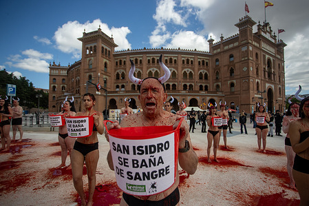 An activist covered with a substitute blood holds a red bucket during the demonstration. Animal rights organizations AnimaNaturalis and CAS International held a protest at the Las Ventas Bullring in Madrid, coinciding with the San Isidro Festival. Fifty activists covered their bodies with buckets of blood (a substitute) to represent the death of bulls during these Madrid festivities, while others accompanied them with slogans against bullfighting.