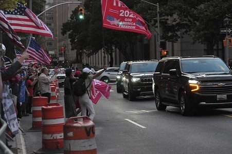 Pro-Trump demonstrators wave as Donald Trump's motorcade leaves Manhattan Criminal Court. Former U.S. President Donald Trump attended trial at Manhattan Criminal Court after being accused of falsifying business records to hide hush money payments made to cover Trump's extramarital affairs. Trump is being charged in New York with 34 counts of falsifying business records. Closing arguments in the trial began on Tuesday, May 28. The trial is the first criminal trial of a former U.S. president.