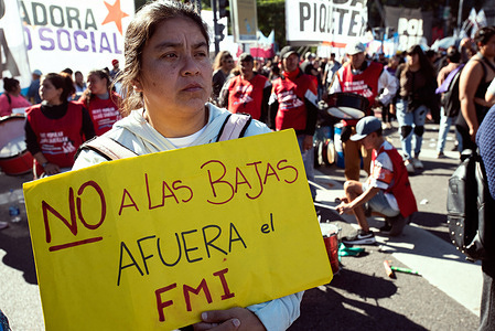 A woman holds a placard that says: "No to the causalities, out IMF" during the demonstration. Unemployed and informal workers held a protest in Buenos Aires to demand more subsidies from the national government.
