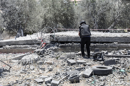 A Palestinian policeman inspects explosives left behind by the Israeli military after they demolished a home in the town of Qabatiya, south of Jenin, in the West Bank. Israeli military forces blew up three homes of Palestinians, in the town of Qabatiya, which Israel accuses of killing three Israeli settlers and injuring others near the West Bank settlement of Kodumim.