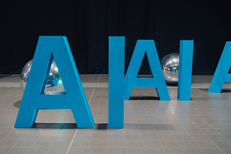 A blue ‘AI’ sign seen during an IT conference.