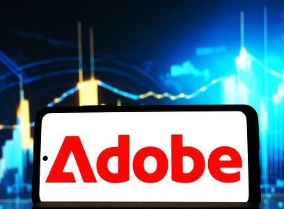 In this photo illustration, the Adobe Inc. logo seen displayed on a smartphone.