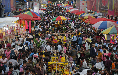 A crowd gathers at Dadar market in South Mumbai to shop on the eve of the Ganesh Chaturthi festival. Devotees offer prayers to the elephant-headed Hindu god Ganesha, revered as the deity of knowledge, wisdom, and prosperity, during the ten-day festival.