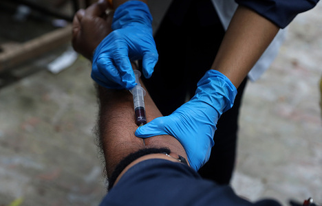 A medical personnel collecting a blood sample from a man during the tests.
Indian Health Workers conduct serological tests about antibodies generated by the immune system against the Coronavirus. In India more than 55,000 cases add up each day with a total of 2,027,074 confirmed cases and 41,638 deaths by the COVID-19 diseases.