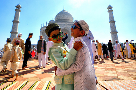 Muslim children greet each other after offering prayers at the Taj Mahal. Muslims around the world are celebrating the Eid al-Fitr holiday, which marks the end of the fasting month of Ramadan.