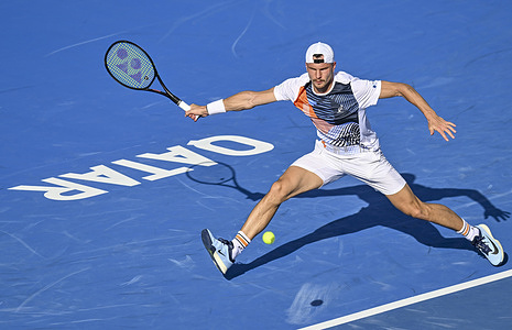 Marton Fucsovics of Hungary is seen in action against Karen Khachanov of Russia during their men's singles round of 16 match at the ATP Qatar Exxonmobil Open 2026 tennis tournament at the Khalifa International Tennis Complex. Karen Khachanov won against Marton Fucsovics 6-2,4-6,6-4.
  
