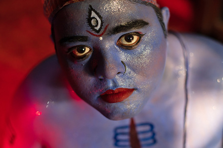 A Hindu devotee appears with makeup as Lord Shiva to participate in the Lal Kach procession at Munshiganj. The Hindu men paint themselves with red color and attend a procession holding swords as they show power against evil sprits in the very last day of Bangla calendar and welcoming another Bangla New Year at Munshiganj.
